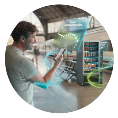 Imagem do sensor, do aplicador e de um telemóvel a mostrar o ecrã da aplicação MCG